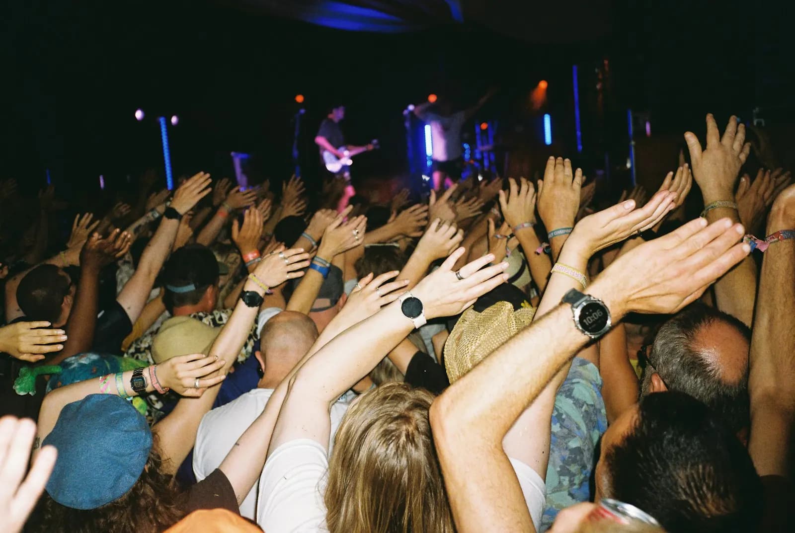Crowd with arms raised at a concert