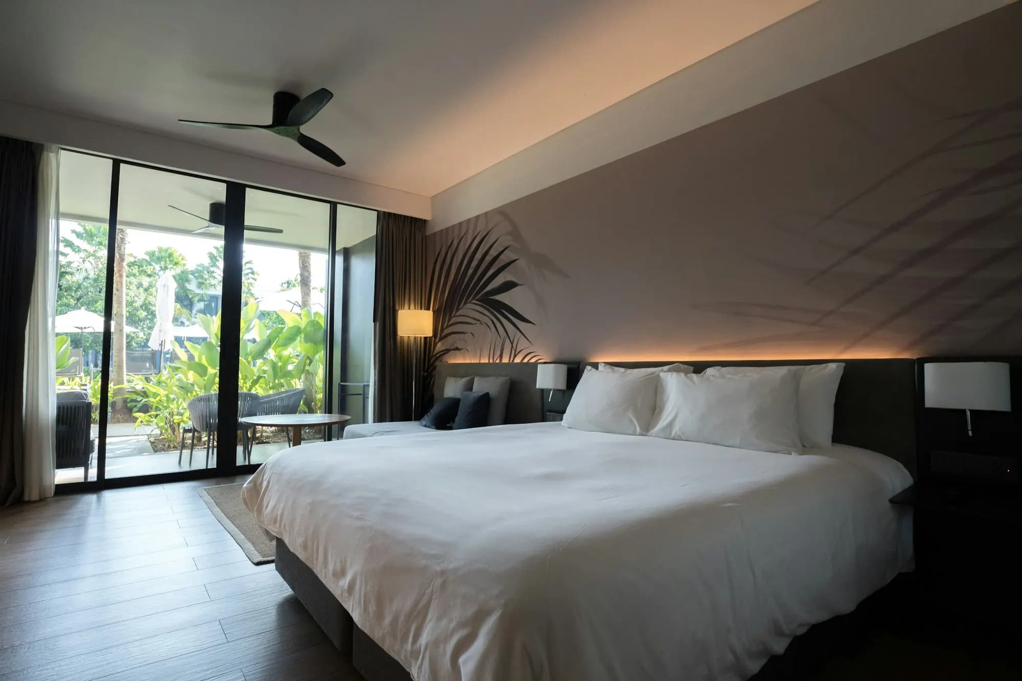 Hotel room with a large bed and a balcony view