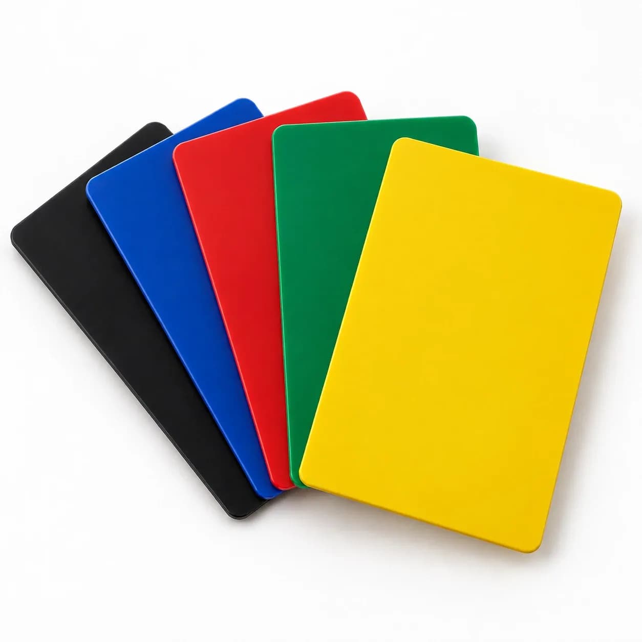 Black, blue, red, green and yellow colored core key cards fanned out, solid color through to the edges