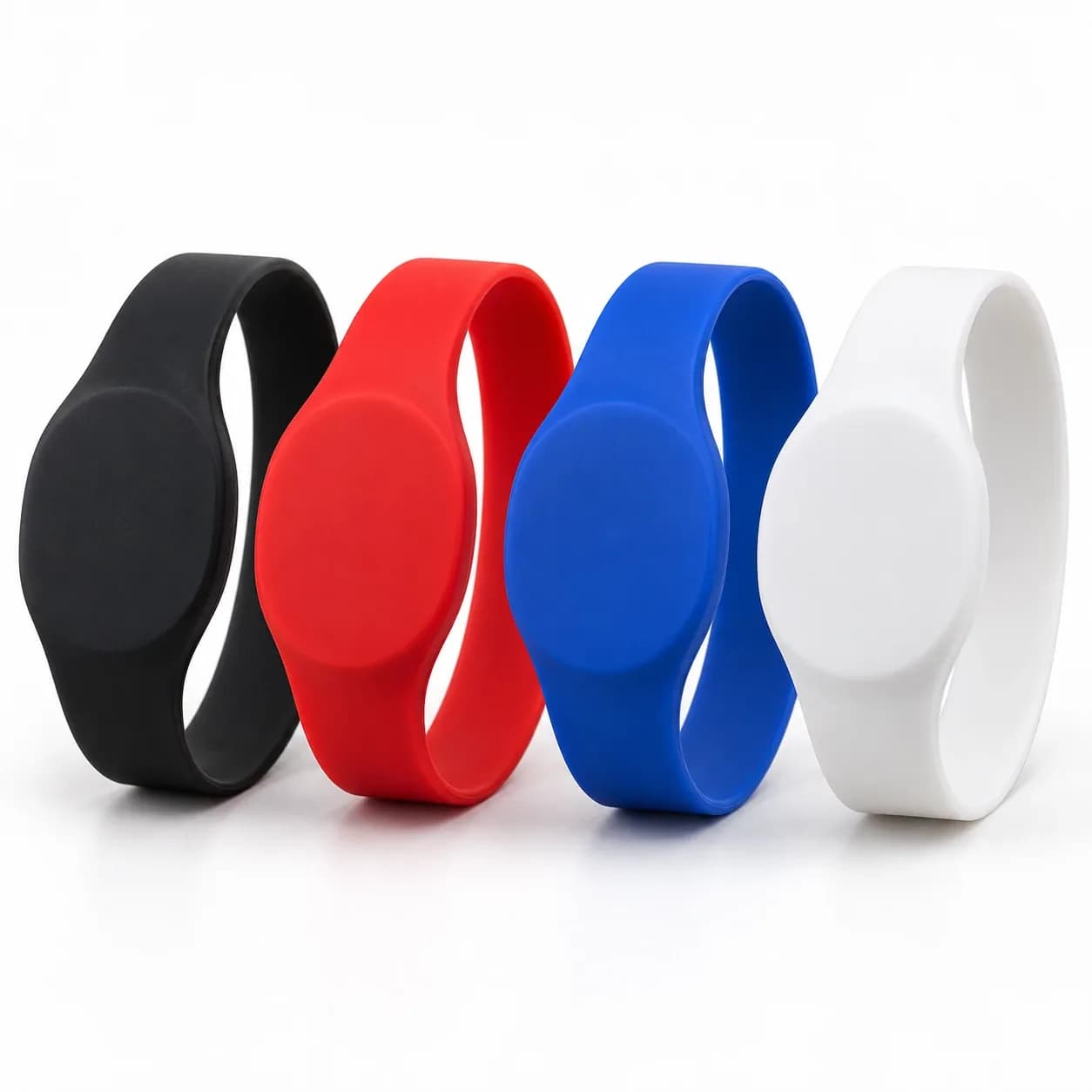 Black, red, blue and white silicone RFID wristbands with oval chip faces in a row